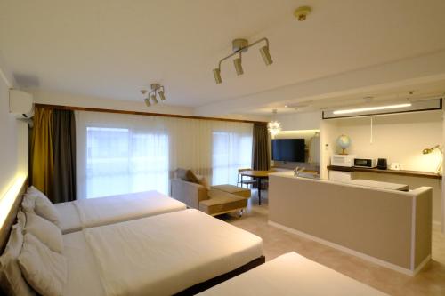 a hotel room with a bed and a kitchen at Namba Hara apartment in Osaka