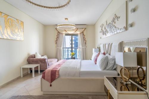 a bedroom with a large bed and a chandelier at Veer Apartments in Dubai