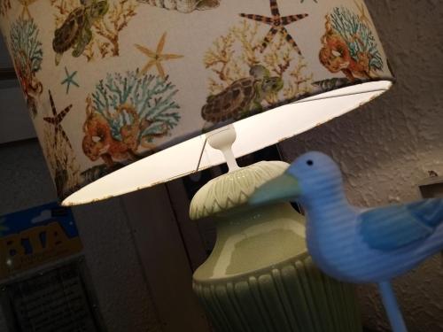 a lamp with a blue bird on a light fixture at Schofield Guest House in Bridlington