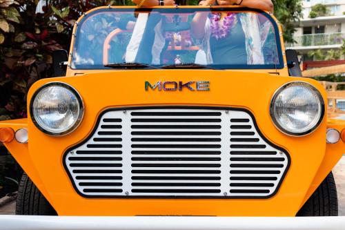 an orange truck is parked on a street at Wayfinder Waikiki - Voted Top 10 Best Hotels in Hawaii! in Honolulu