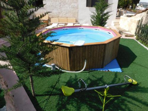 a jacuzzi tub in a yard with a tree at Michaela's House in Tsikalariá