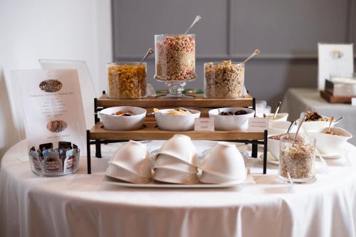 a table with bowls of food and shoes on it at RELAIS CASCINA ERA in Sandigliano