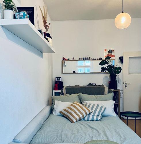 a bedroom with a bed with pillows on it at 1 room apartment in Friedrichshain in Berlin