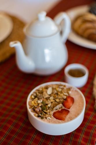 a bowl of food on a table with a tea pot at Wildflower Villas - All Villa Hotel, Family Run in Candolim