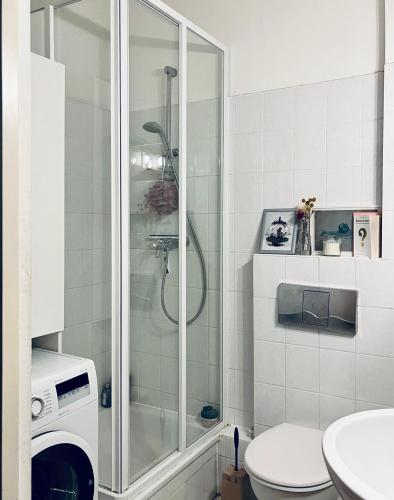 a bathroom with a shower and a toilet at 1 room apartment in Friedrichshain in Berlin