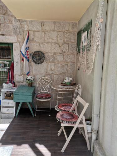 a patio with two chairs and a table and a desk at Studio Milla in Split