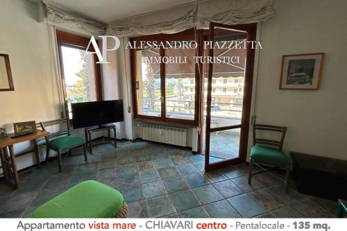 a living room with a window and a television and a room at ML in passeggiata mare in Chiavari