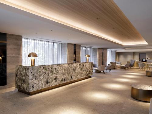 a lobby of a hotel with a marble counter at HOTEL THE LEBEN OSAKA in Osaka