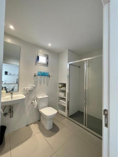 a bathroom with a toilet and a sink and a shower at Apartaments La Perla Negra in Cala Ratjada