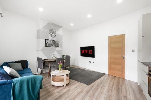 a living room with a couch and a table at 3BR Duplex Penthouse Harrow centre in Harrow