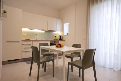 a kitchen with a table and chairs in a room at Keys of Sicily - Appartamenti Modica Bassa in Modica