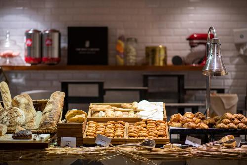 a bakery counter with various types of bread and pastries at The Ritz-Carlton Abu Dhabi, Grand Canal in Abu Dhabi