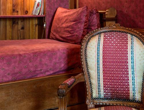 a bedroom with a bed and a chair at Château de l'Abbaye - Teritoria in Moreilles