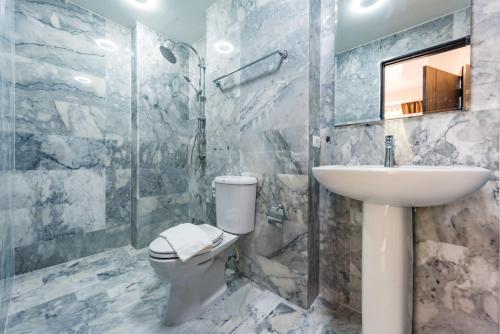 a bathroom with a toilet and a sink and a shower at Mai Khao Beach Condotel - family condo in 600 meters to beach in Ban Bo Sai Klang