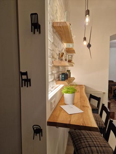 a kitchen with a wooden counter with chairs and a table at 4 seasons apartment in Vienna