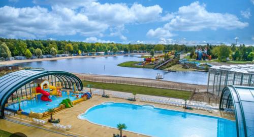 an amusement park with a large swimming pool at 8 p bungalow in bossen bij Capfun Stoetenslagh in Rheezerveen