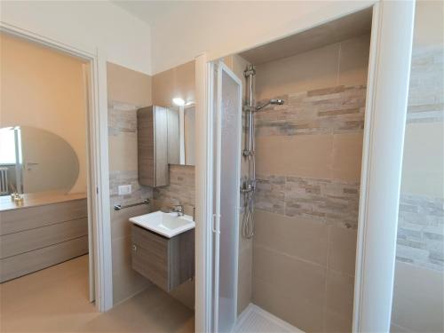 a bathroom with a sink and a shower at Winter Spring Summer Apartments in Mergozzo