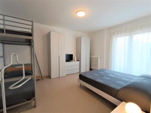 a bedroom with a bunk bed and a television at Winter Spring Summer Apartments in Mergozzo