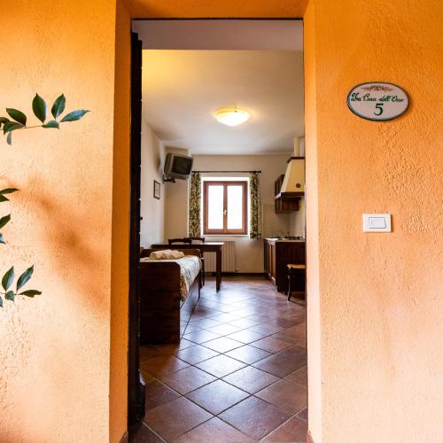 a hallway with a room with a bed and a table at Antico Borghetto - Casa Vacanze in Norcia