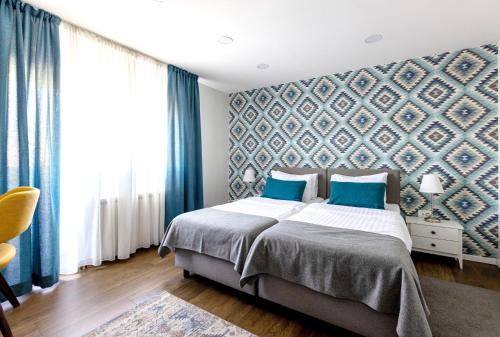 a bedroom with a bed with blue walls and blue curtains at Apartment Sovre in Belgrade