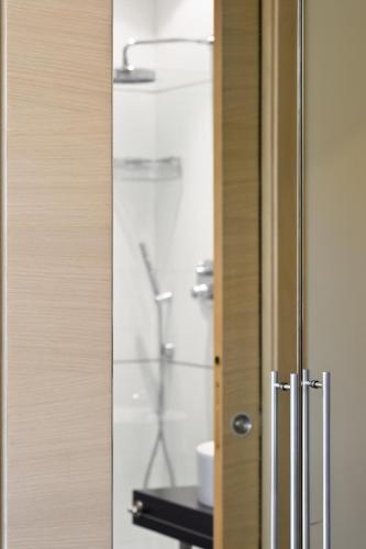 a glass door with a shower in a bathroom at Best Western Hotel San Marco in Siena