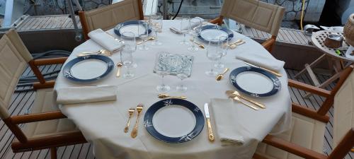 a white table with plates and glasses on it at Yacht Charter Nice Cannes Antibes in Nice