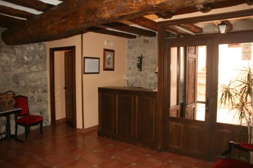 a room with a door and a table and chairs at Hotel Olimpia in Albarracín