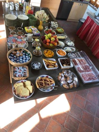 a table topped with lots of different types of food at Villa de' Ricci Rignana B&B in Greve in Chianti