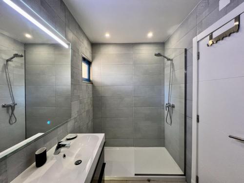 a white bathroom with a shower and a sink at Vilamoura Prestige With Pool by Homing in Vilamoura