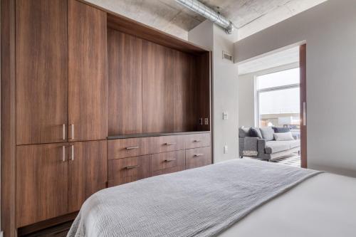 a bedroom with wooden cabinets and a bed at Downtown 1BR w Gym Roof WD nr Pike Pl Mkt SEA-239 in Seattle