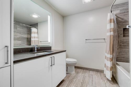 a white bathroom with a sink and a toilet at Downtown 1BR w Gym Roof WD nr Pike Pl Mkt SEA-239 in Seattle