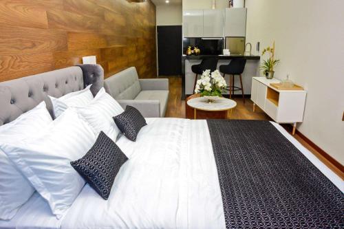 a bedroom with a large white bed with pillows at TRYP by Wyndham Santa Cruz in Santa Cruz de la Sierra