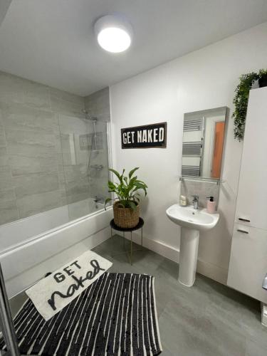 a bathroom with a tub and a sink and a toilet at Seadream Luxury Hot Tub Holiday Home Homesweetholidayhomes in Scarborough