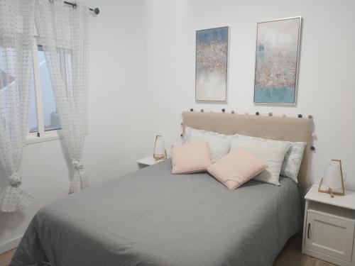 a bedroom with a bed with two pink pillows at Índigo in Santa Cruz de la Palma