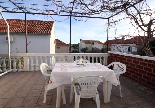 a white table and chairs on a balcony at Apartment Orebic 4526b in Orebić