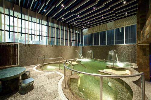 a room with a pool of water in a building at One Fukun Hotel in Jiaoxi