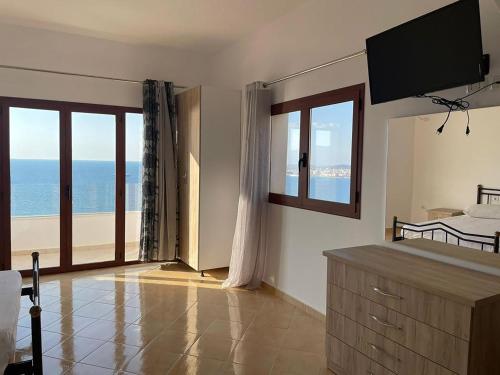 a bedroom with a bed and a view of the ocean at Vila Dena in Vlorë
