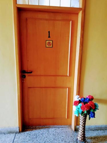 a door with a vase of flowers in front of it at Renajoe Exclusive Guesthouse Tema Community 9 in Tema