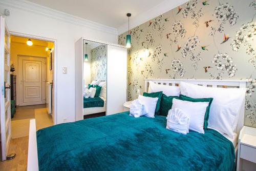 1 dormitorio con 1 cama grande con manta azul en Hillside Lodge, en Budapest