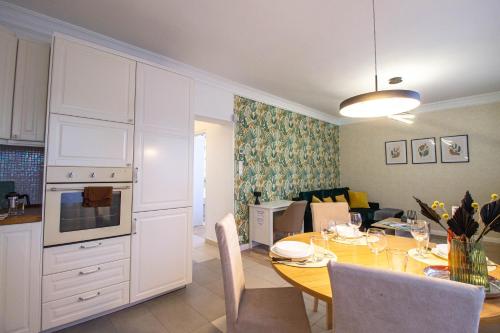 a kitchen and living room with a table and a kitchen and a dining room at Hillside Lodge in Budapest