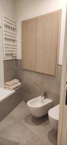 a bathroom with a sink and a toilet and a mirror at Maison Dolce Vita in Rome