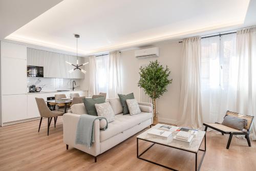 a living room with a white couch and a table at Luxury flat Atocha I in Madrid