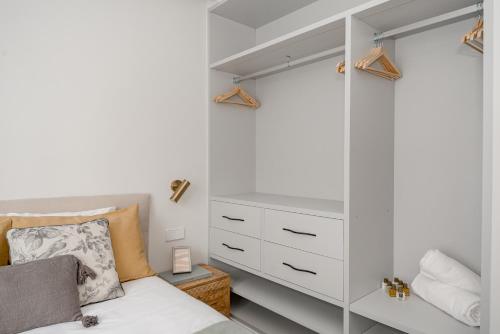 a bedroom with a white cabinet and a bed at Luxury flat Atocha I in Madrid