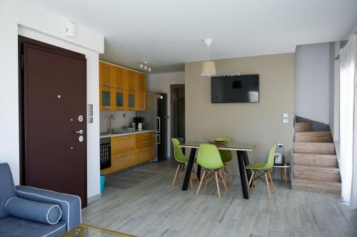 a kitchen and dining room with a table and chairs at Urban Chic Apartments Lefkada in Lefkada Town