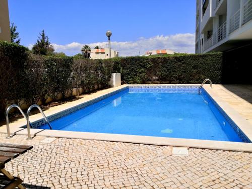 a small swimming pool in a courtyard with a building at Orange Flat - POOL-WIFI - Portimão in Portimão