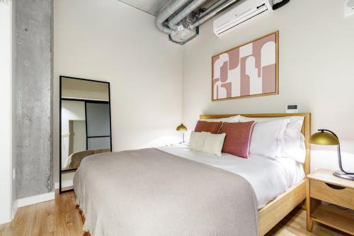 a bedroom with a large white bed and a mirror at Downtown 1BR w Gym WD walkable location SEA-48 in Seattle