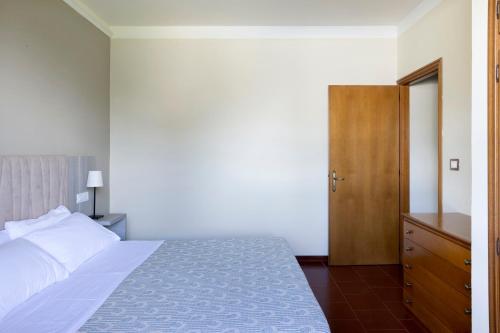 a bedroom with a bed and a wooden door at Tenuta Lamborghini Golf & Resort in Panicale