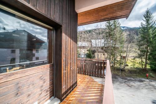 a house with a balcony with a large window at Majestic Richebourg in Abondance