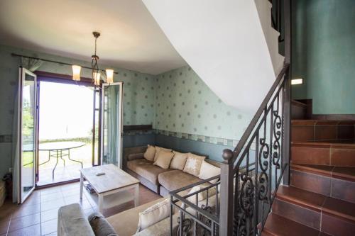 a living room with a couch and a table at Malvazios Villas #4 in Gythio