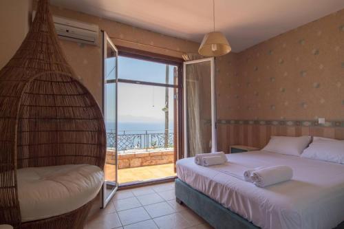 a bedroom with two beds and a balcony with the ocean at Malvazios Villas #4 in Gythio